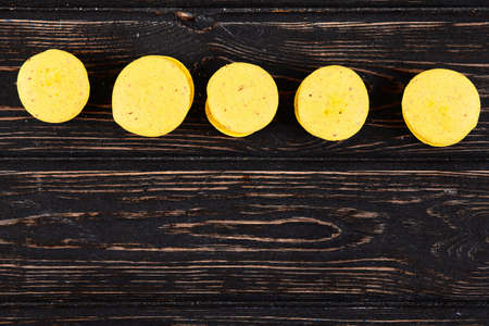 Fresh colored macaroons on wood desk. Food backgroundの写真素材