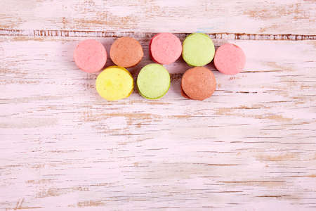 Fresh colored macaroons on wood desk. Food backgroundの写真素材