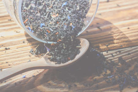 Dry tea in wood spoon. Food backgroundの写真素材