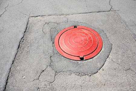 red sewer on asphalt outdoor. city infrastructure