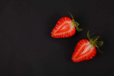 Ripe fresh strawberry on black background. Fruits close up