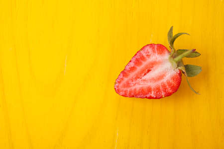 Ripe fresh strawberry on yellow background. Fruits close upの写真素材