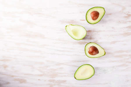 Green fresh ripe avocado on wood desk. Food ingredientsの写真素材