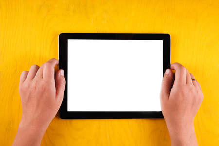 Computer tablet with hand. Top view. Place for textの写真素材