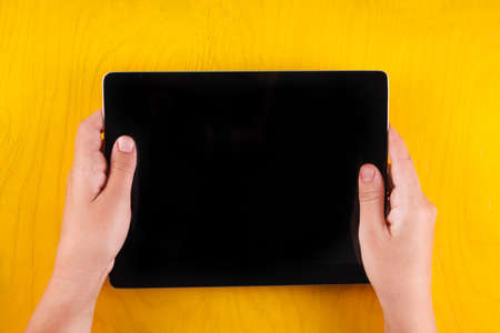 Computer tablet with hand. Top view. Place for text