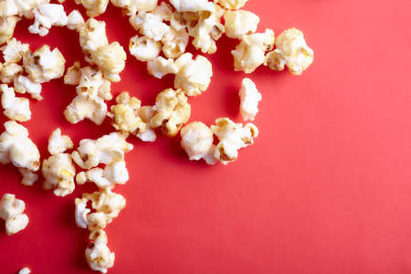 Paper cup with popcorn on color background. Fast food. Cinema concept. Top view.の写真素材
