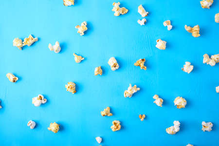 Paper cup with popcorn on color background. Fast food. Cinema concept. Top view.の写真素材