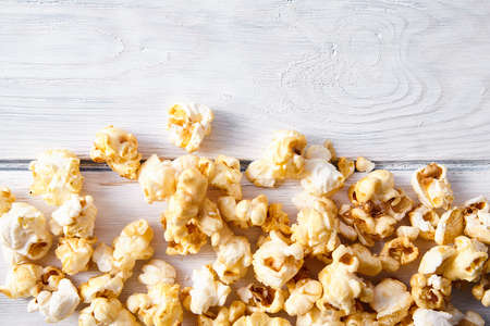 Paper cup with popcorn on color background. Fast food. Cinema concept. Top view.の写真素材