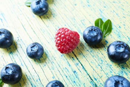 Ripe fresh raspberry and blueberry close up. Food ingredients