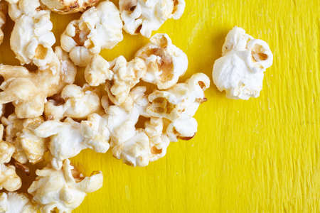 Sweet fried popcorn close up on color background. Food ingredients