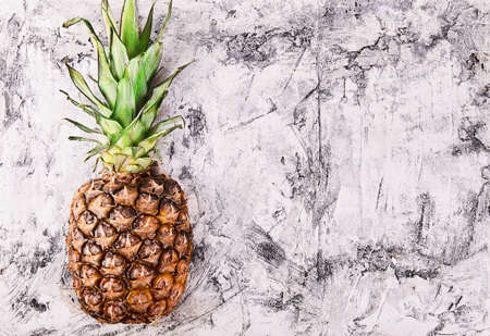 Fresh pineapple close up on wood desk with place for text