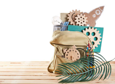 Backpack with supplies on wood desk with place for text. Education concept. Back to schoolの写真素材