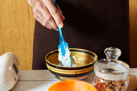 the process of cooking macaroons. the cook kneads the doughの写真素材