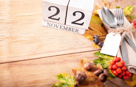 Thanksgiving autumn place setting with cutlery and arrangement of colorful fall leavesの写真素材