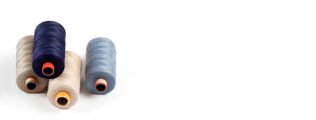 Color sewing threads on white background, top view