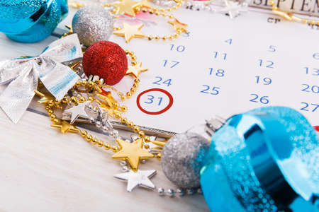 Christmas composition. Christmas gift, knitted blanket, pine cones, fir branches on wooden white background. Flat lay, top view, copy spaceの写真素材