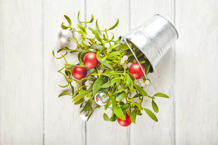 Broom from green mistletoe on wood desk. Nature background. Christmas plantの写真素材