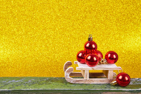Christmas sled on gold background with copy spaceの写真素材