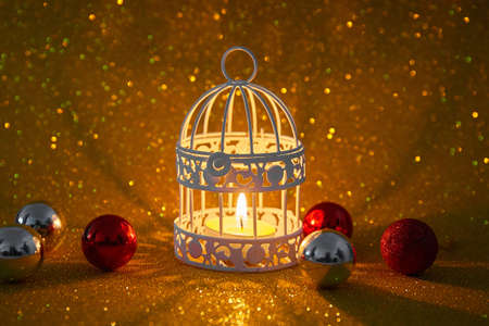 Burning candle and Christmas decoration over snow and wooden background, elegant low-key shot with festive moodの写真素材