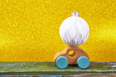 Wood car with christmas decorations. Place for text. Gold backgroundの写真素材