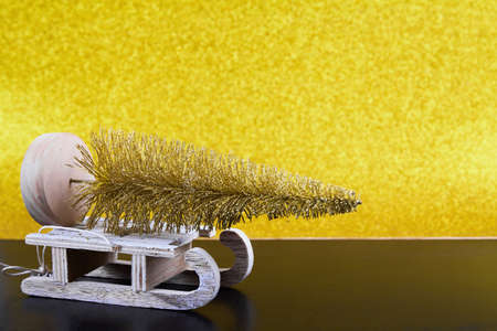 Christmas sled on gold background with copy spaceの写真素材