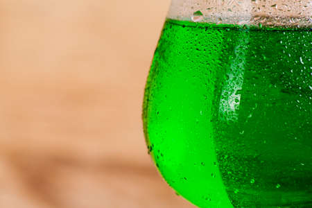 St. Patricks Day green shamrocks with a full cold frosty glass of beerの写真素材