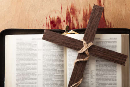 Closeup of simple wooden Christian cross necklace on Bible , vintage tone , Godの写真素材