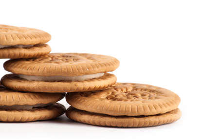 Dry thin crackers in a wrapping paper and on a sackcloth isolated on whiteの写真素材