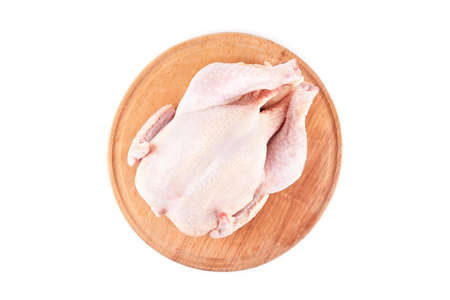 raw chicken carcass on wood desk isolated on white backgroundの写真素材