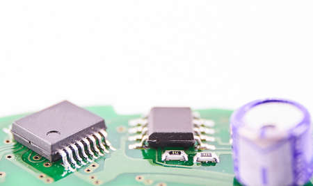 Printed Circuit Board with many electrical components on white background