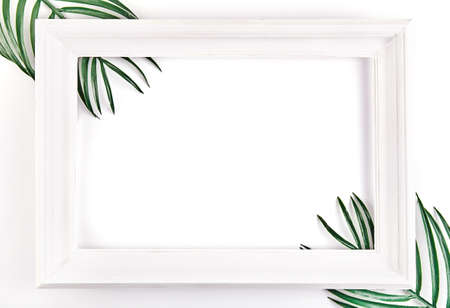 Creative layout made of tropical leaves with vintage frame. Flat lay. Nature conceptの写真素材