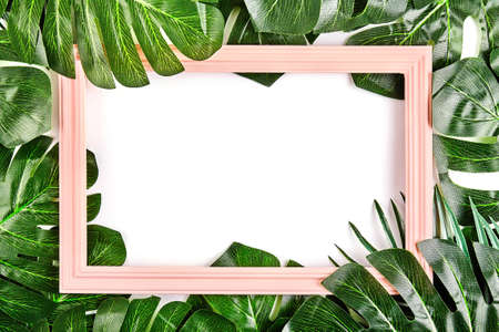 Creative layout made of tropical leaves with vintage frame. Flat lay. Nature conceptの写真素材