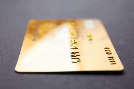 Gold credit cards closeup on black backgroundの写真素材