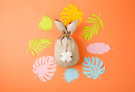 Creative Paper bunny on coral background. Easter layout