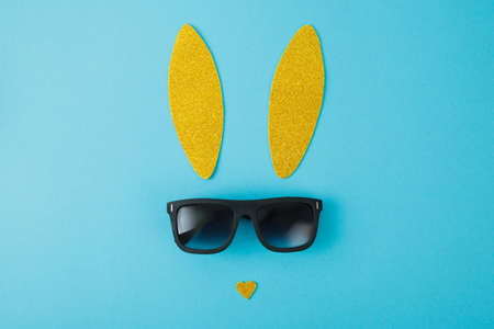 Creative easter background with bunny ears and sunglasses on white backgroundの写真素材