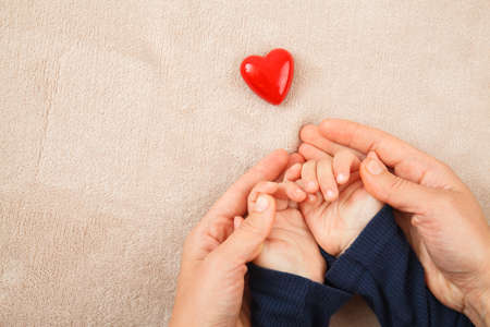 adult and child hands holding red heart, health care, donate and family insurance concept,world heart day, world health day, CSR conceptの写真素材