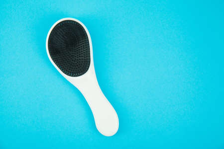 Hairbrush on blue background. Place for textの写真素材