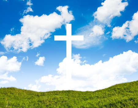 The Cross with bright sun and clouds in the backgroundの写真素材