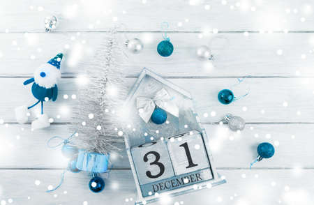 Christmas composition. Christmas gift, knitted blanket, pine cones, fir branches on wooden white background. Flat lay, top view, copy spaceの写真素材