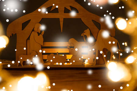 Christmas Nativity Scene of baby Jesus in the manger with Mary and Joseph in silhouette surrounded by the animals and wise men with the city of Bethlehem in the distance withの写真素材