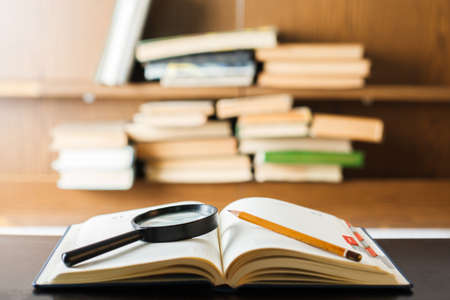 Education concept. Stack of books on table. Blur bookshelf backgroundの写真素材
