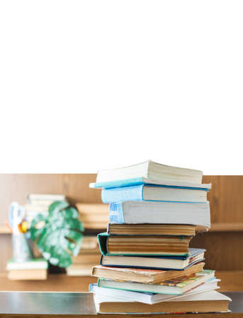 Education concept. Stack of books on table. Blur bookshelf backgroundの写真素材