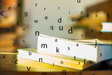 Education concept. Stack of books on table. Blur bookshelf backgroundの写真素材
