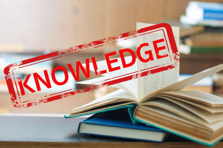 Rubber stamp knowledge on book. Education conceptの写真素材