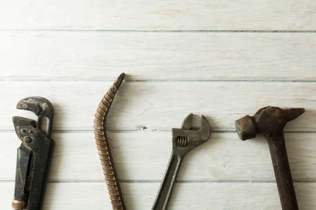 construction tools on wooden background with space for copy. Hammer, screwdriver, wrench