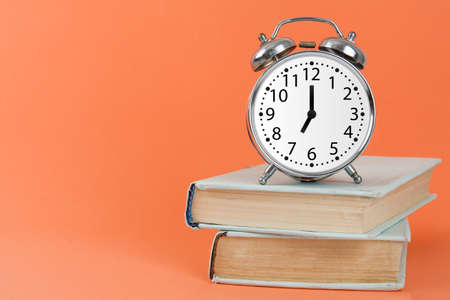 Silver vintage alarm clock on pink backgroundの写真素材