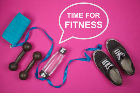 Fitness background with bottle of water, sport shoes on color texture
