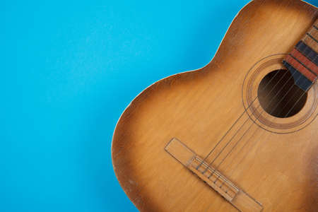 Acoustic guitar resting on color background with copy space. Modern conceptの写真素材