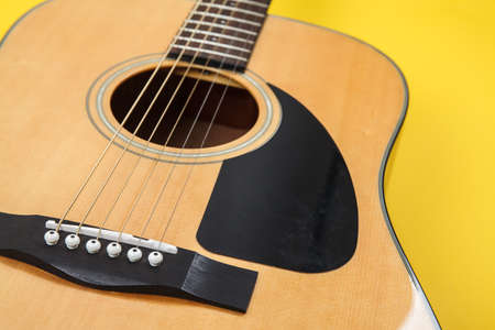 Acoustic guitar resting on color background with copy space. Modern conceptの写真素材