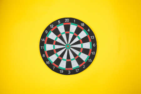Target dart on yellow background. Place for textの写真素材